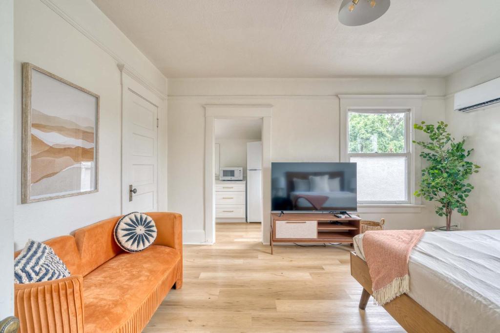 a living room with a couch and a television at Stay Portland - The Sullivan's Gulch Retreat - 94 Walk Score in Portland