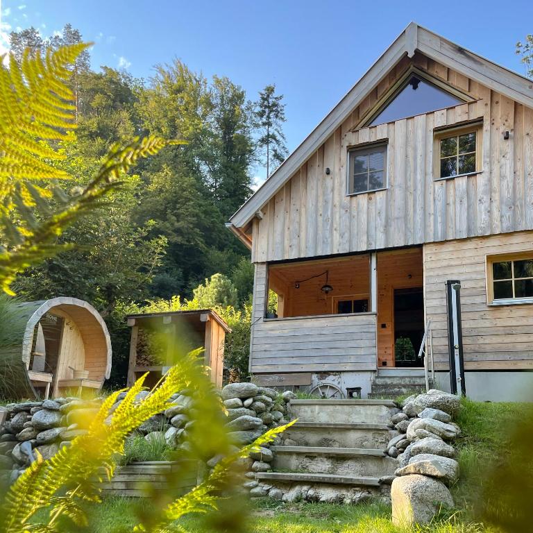 a wooden house with stairs in front of it at Rodlhaus GruBÄR - Rodltal-Huetten in Maierleiten