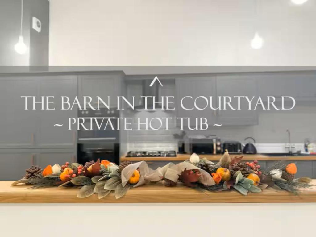 a sign that says the barn in the courtyard pumpkin hot tub at The Barn in The Courtyard, 3 - Bed, Sleeps 5, Pets Welcome in Ulverston