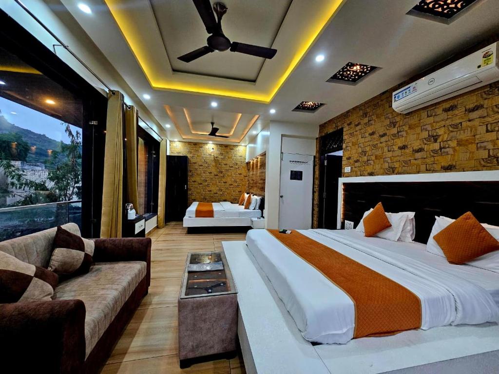 a bedroom with a large bed and a couch at Hotel Leela Vilas Pushkar -A Boutique Hotel in Pushkar