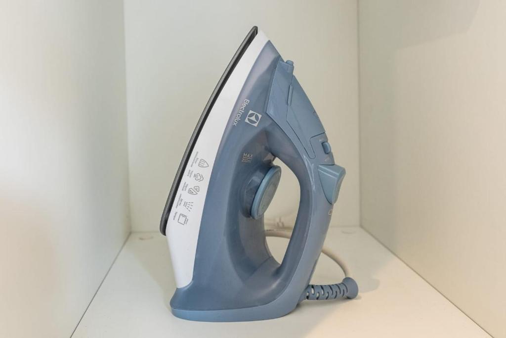 a blue telephone sitting on a white floor at Brás Downtown Residence Flat in Sao Paulo