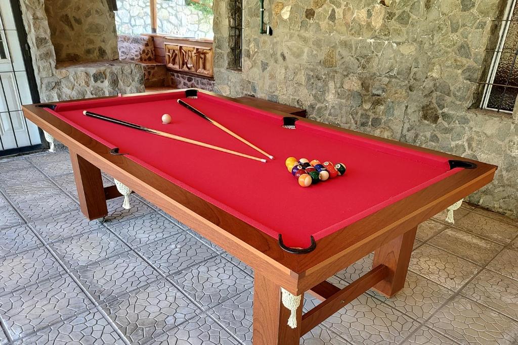 a red pool table with balls on top of it at Vado Biguá in Valle Hermoso