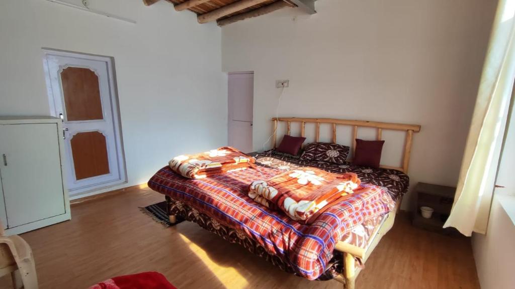 a bedroom with a bed with a blanket on it at Serenity Stay Rangrik in Kaza