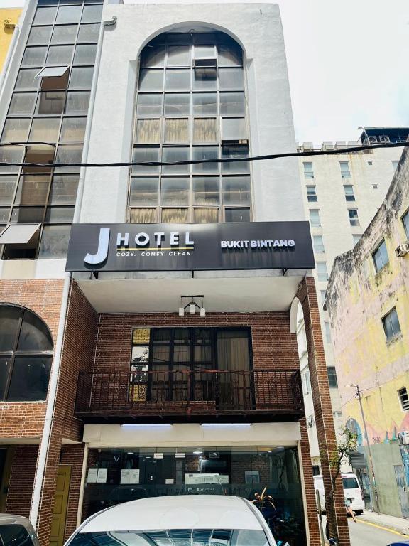 a hotel with a car parked in front of it at J Hotel Bukit Bintang in Kuala Lumpur