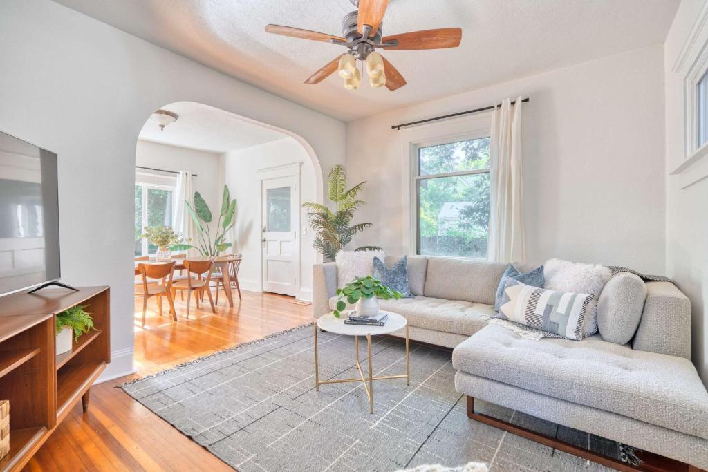 a living room with a couch and a ceiling fan at Stay Portland - Cute & Charming Portland Home 91 WalkScore in Portland