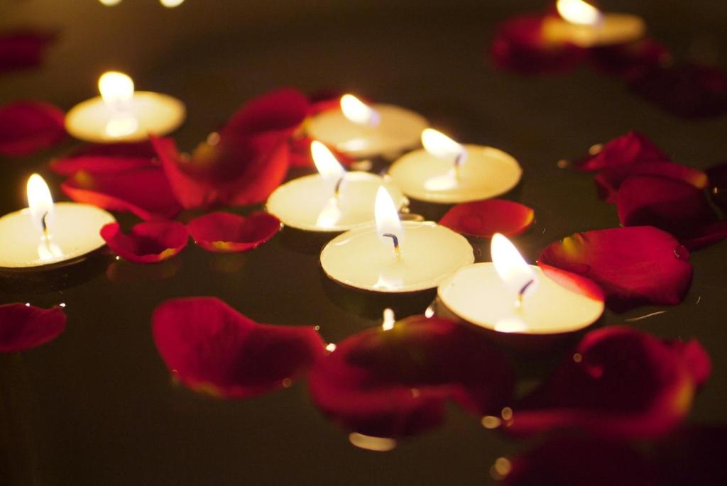 a group of candles and flowers in the water at Fernhill Hotel in Lyme Regis
