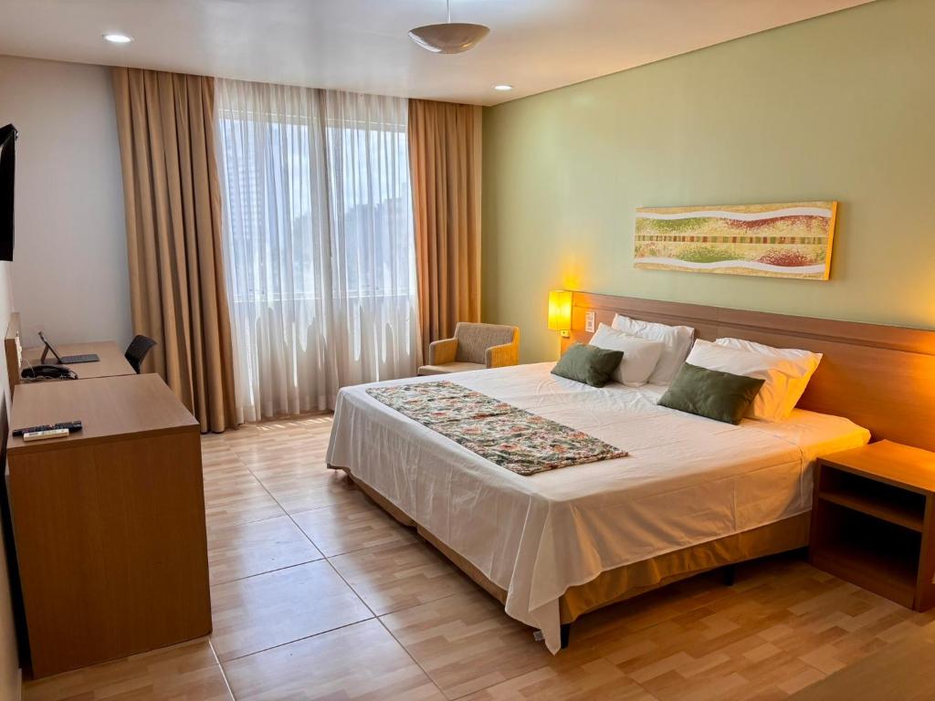 a hotel room with a bed and a desk at Apart-hotel Premium Adrianópolis in Manaus