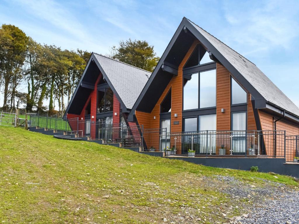 a house on top of a hill with a grass at Briallen - Primrose - Ukc7075 in Mydroilin