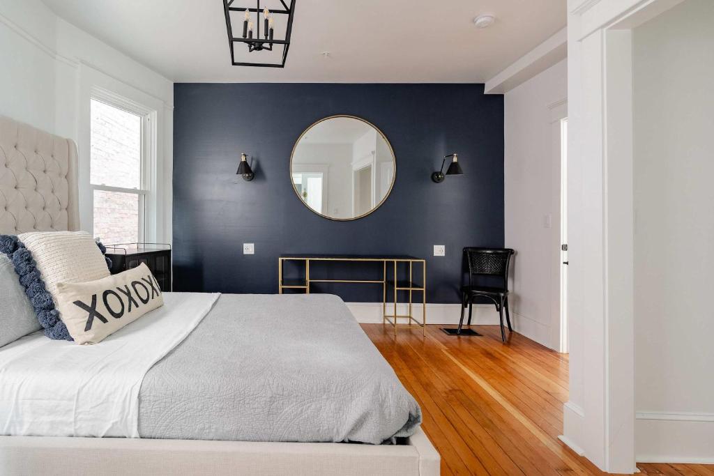 a bedroom with a large bed and a mirror at Stay Portland - Sophisticated 2BR - Prime NW 23rd Location in Portland