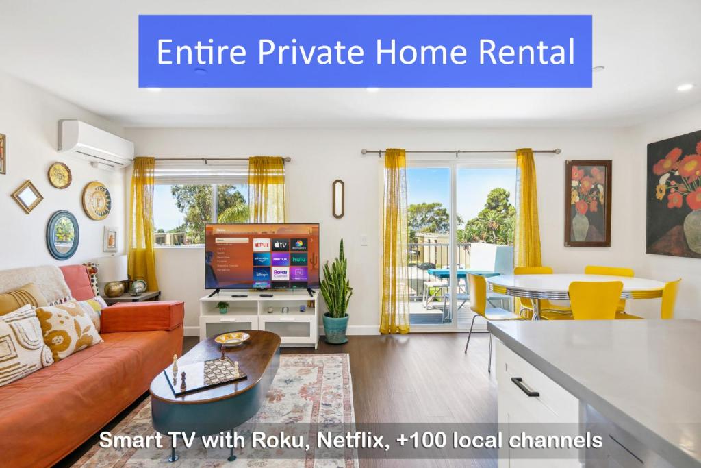 a living room with a couch and a tv at Entire Private 3-BR Home w Balcony Views 10-mins to SD Gaslamp, Downtown, Available Now in National City