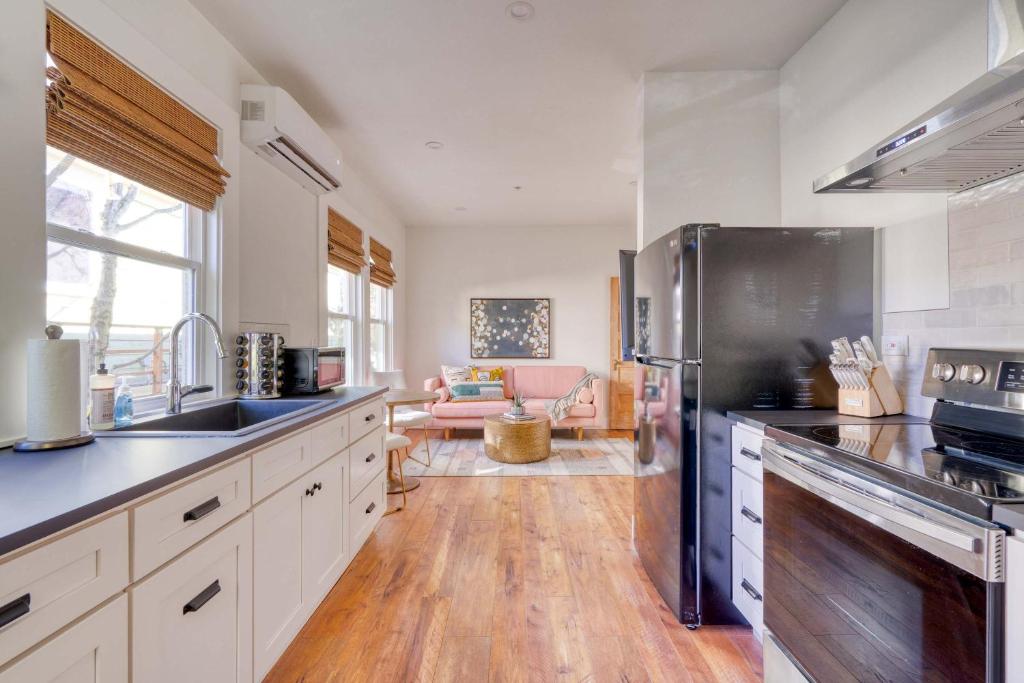 a kitchen with a stainless steel refrigerator at Stay Portland - The Trésor Suite- Cold Brew & Craft Beers in Portland