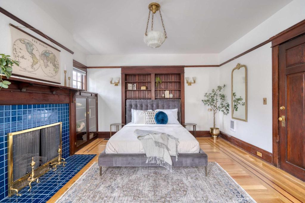a bedroom with a bed and a fireplace at Stay Portland - 1910 Historic Jessie Morehead House - 98 WalkScore in Portland
