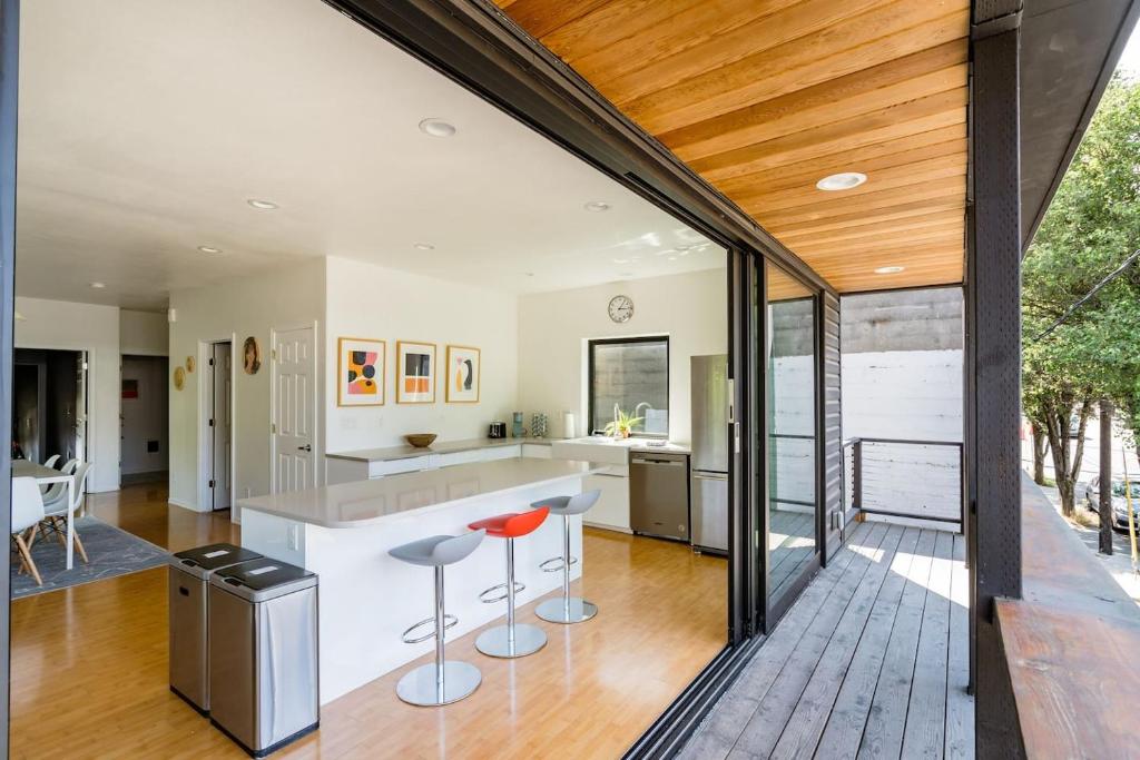 an open kitchen with a bar and stools at Stay Portland - Unique 8 BR Private Home in Pearl District in Portland