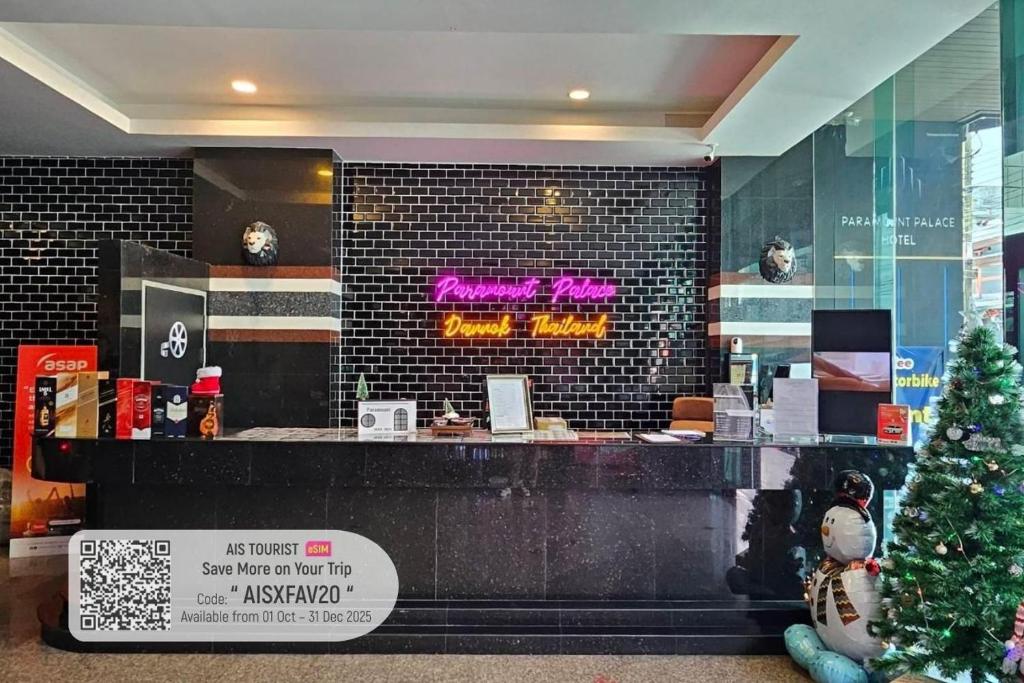 a store with a christmas tree in front of a counter at Paramount Palace Hotel Dannok in Sadao