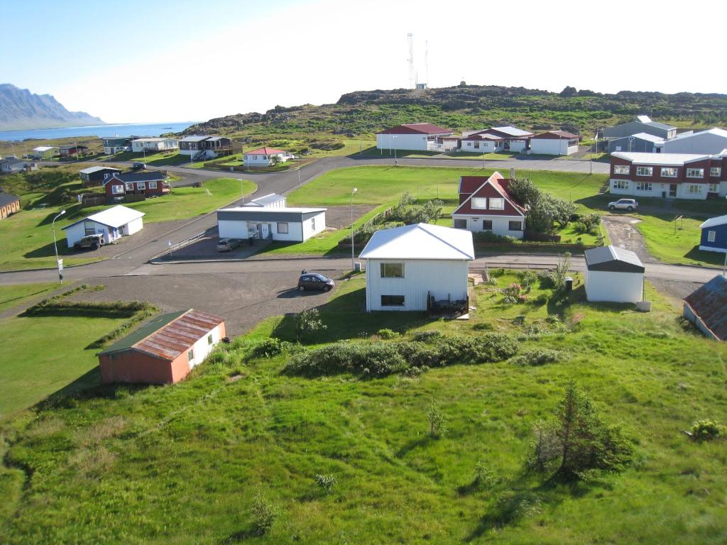 a small village with houses on a grassy hill at Guest House Hammersminni in Djúpivogur
