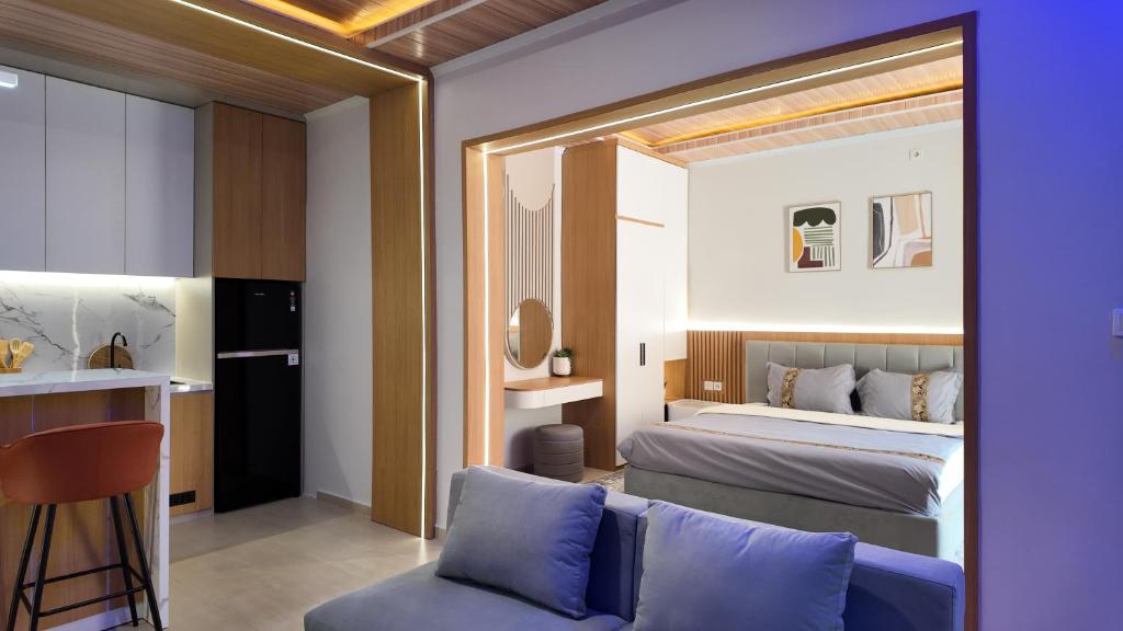 a bedroom with a bed and a couch and a table at Lightstar Modern Villa Mandalika in Kuta Lombok