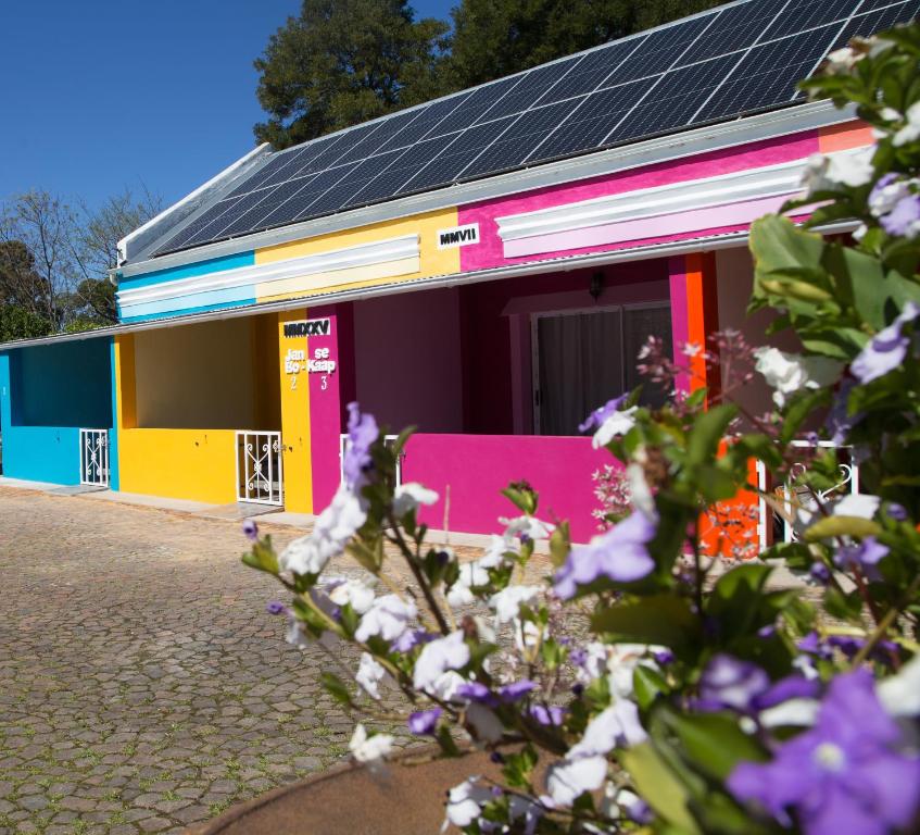 a colorful building with solar panels on it at Storms River Self Catering Apartments in Stormsrivier