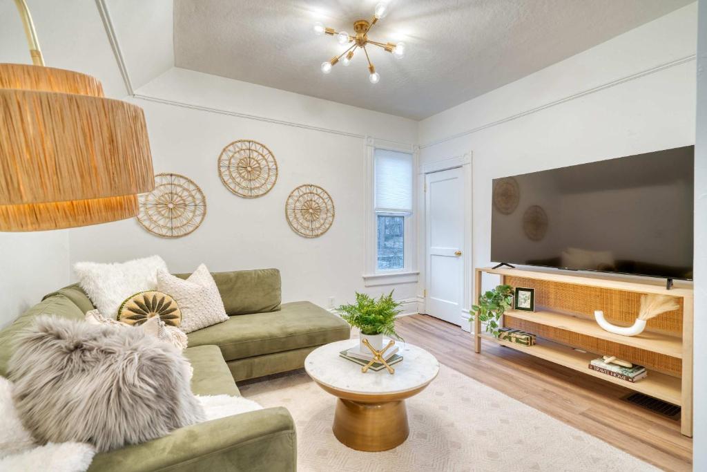 a living room with a couch and a tv at Stay Portland - Historic Queen Anne Vernacular - 95 WalkScore in Portland