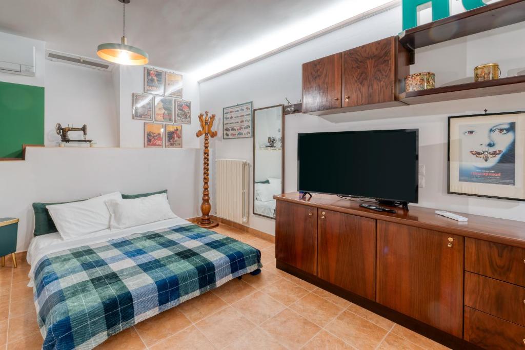a bedroom with a bed and a flat screen tv at Fore te capu casavacanze Lecce in Lecce