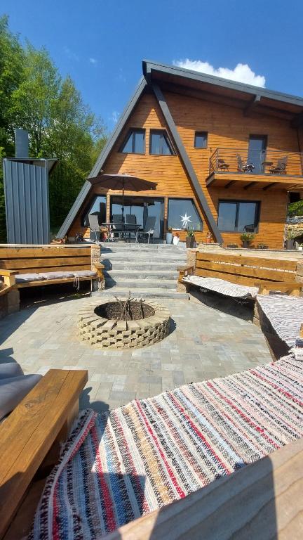 a house with a fire pit in front of it at Restful Haven 