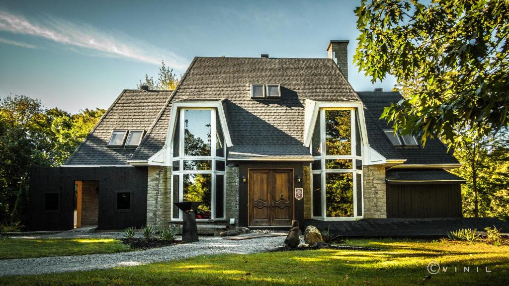 a house with a large window on the front of it at Villa Nao in Roxton Falls