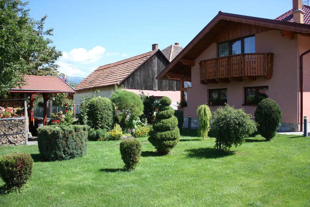 a yard of a house with a bunch of bushes at Apartman Matej in Liptovský Mikuláš