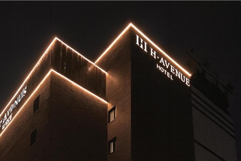 a building with lights on top of it at night at H Avenue Hotel Jeonju Terminal in Jeonju