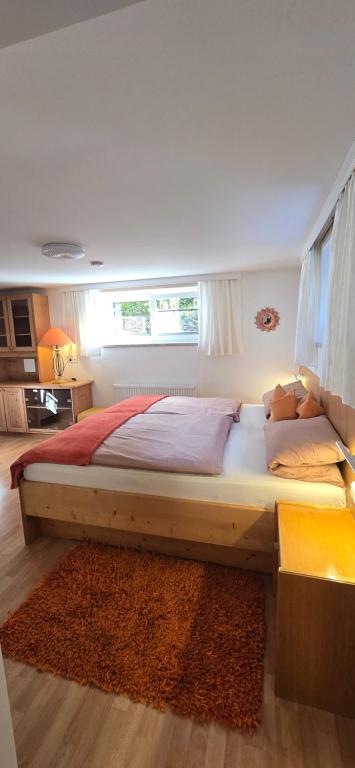 a large bed in a bedroom with a window at Apartment Hausberger in Mayrhofen