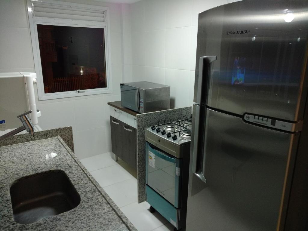 A cozinha ou cozinha compacta de Reserva Pontal Beach