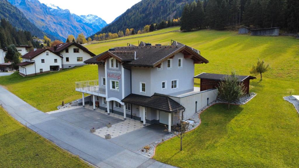 an aerial view of a large house in a field at Ferienwohnung Höllrigl in Sankt Leonhard im Pitztal