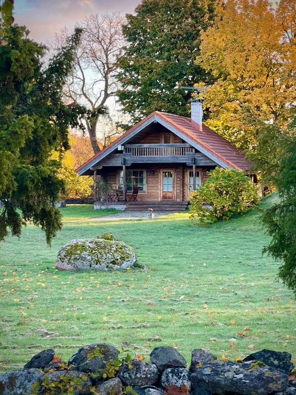 a house in the middle of a field with trees at Kangru Holiday Home in Vanamõisa