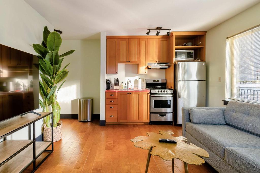 a living room with a couch and a kitchen at Stay Portland - Color Splash Apartment in the Heart of Portland in Portland