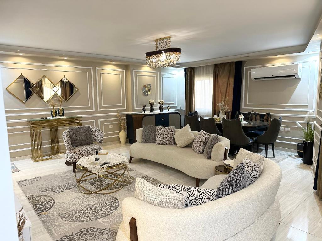 a living room with a couch and chairs and a table at Luxurious apartment in cairo in Cairo