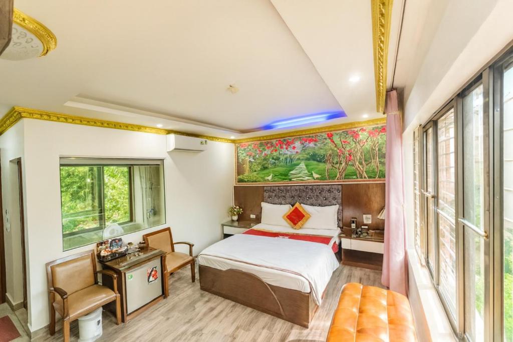 a bedroom with a bed and a large window at Hoàng Gia Long Biên Hotel in Hanoi