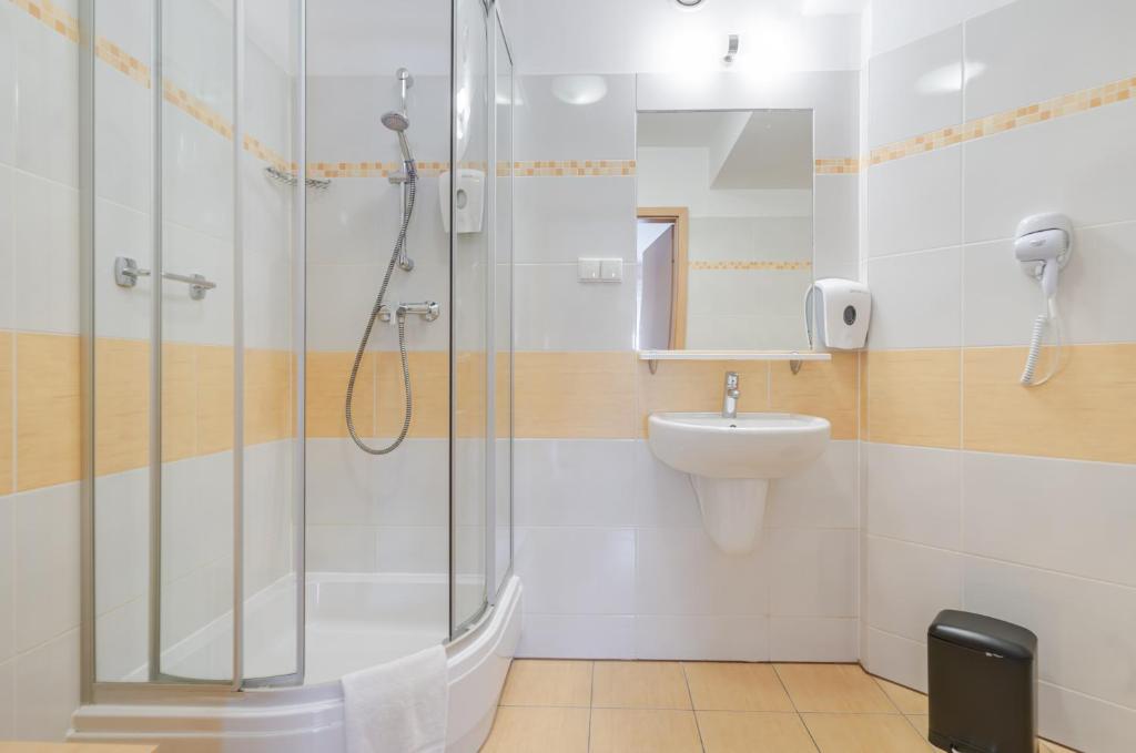 a bathroom with a shower and a sink at Quality Silesian Hotel in Katowice