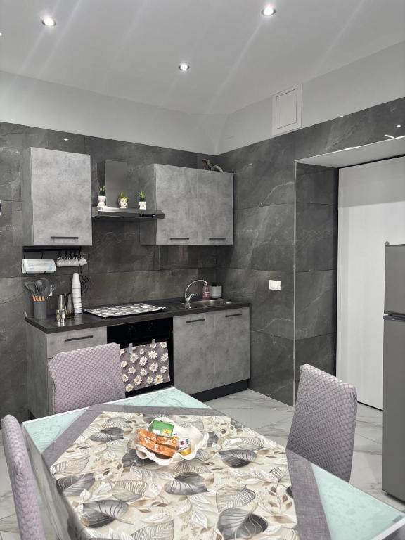 a kitchen with a table and chairs in a kitchen at La casa dei sogni in Torre del Greco