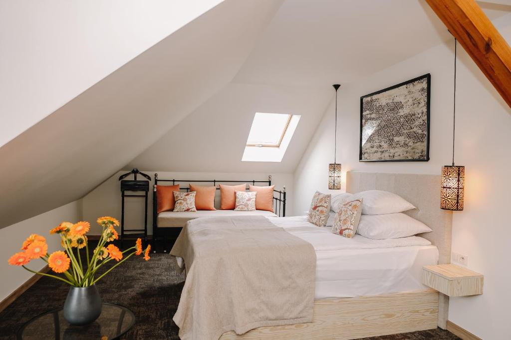 a bedroom with two beds in a attic at Karczma Rzym Bydgoszcz S5 in Bydgoszcz