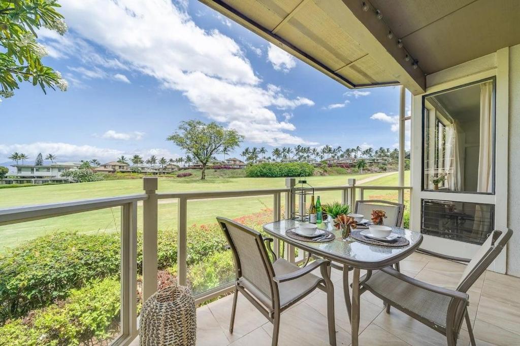 a patio with a table and chairs on a balcony at Grand Champions 163 · GC 163 2BD Wailea Condo w AC Pool Close to in Wailea