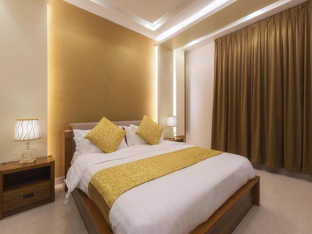 Postel nebo postele na pokoji v ubytování Mrfaaliah for Furnished Apartments مرفا عاليه للشقق المخدومة