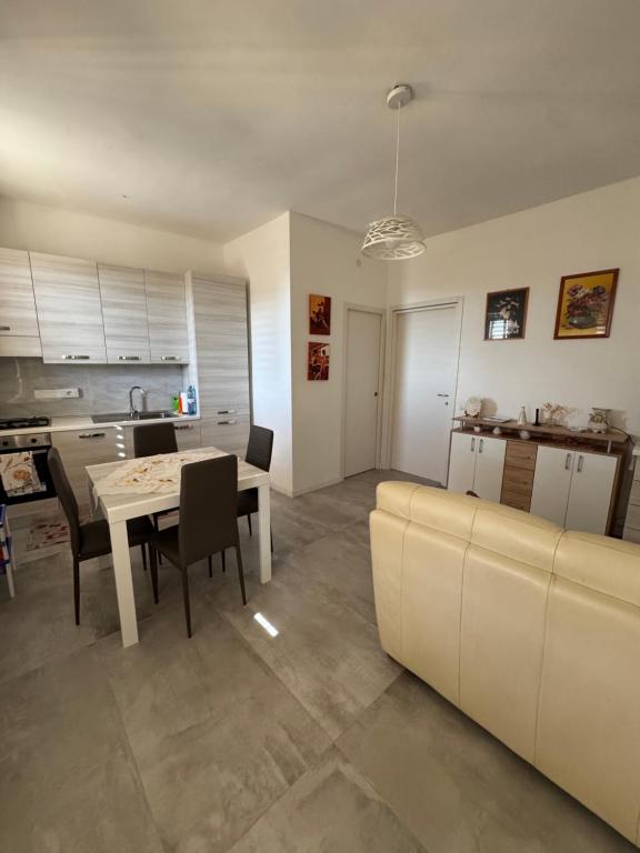 a kitchen and living room with a table and chairs at Donna Maria in Catanzaro