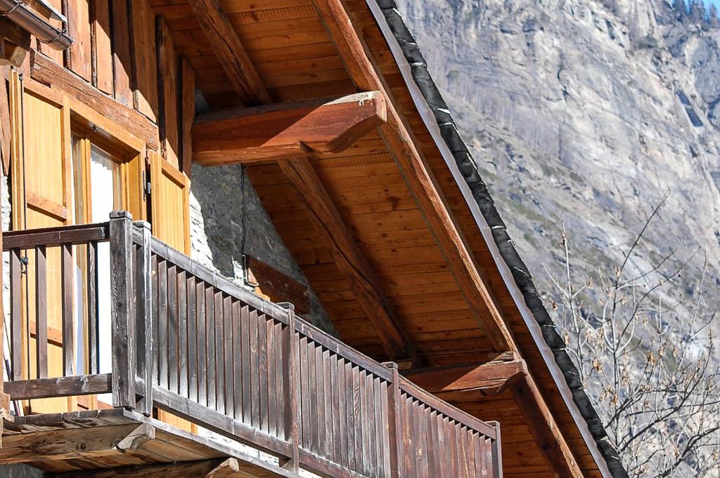 a wooden balcony of a building with a window at Case Gran Paradiso Rhemes Saint Georges Voix in Rhemes-Saint-Georges