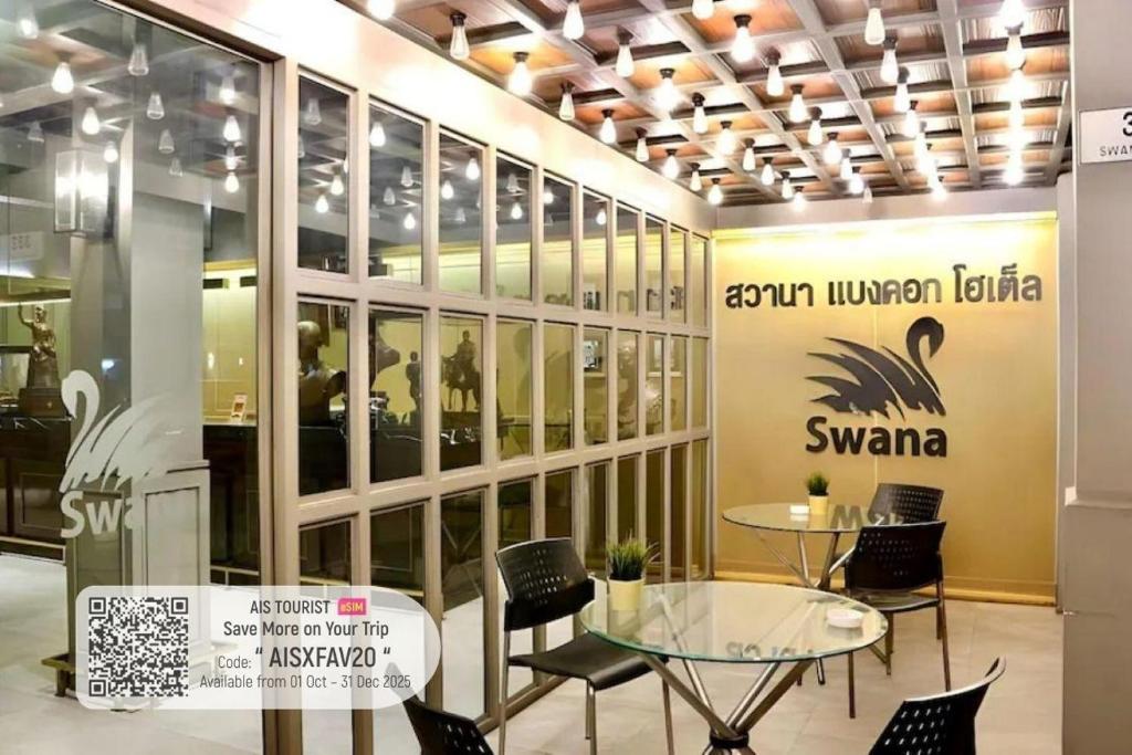 a store with a glass table and chairs in a room at Swana Bangkok Hotel in Bangkok