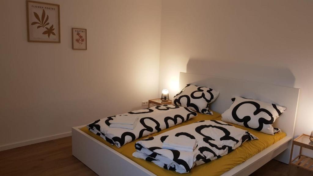 a bedroom with a bed with black and white pillows at ME Apartments Würges 1 2 8 in Bad Camberg