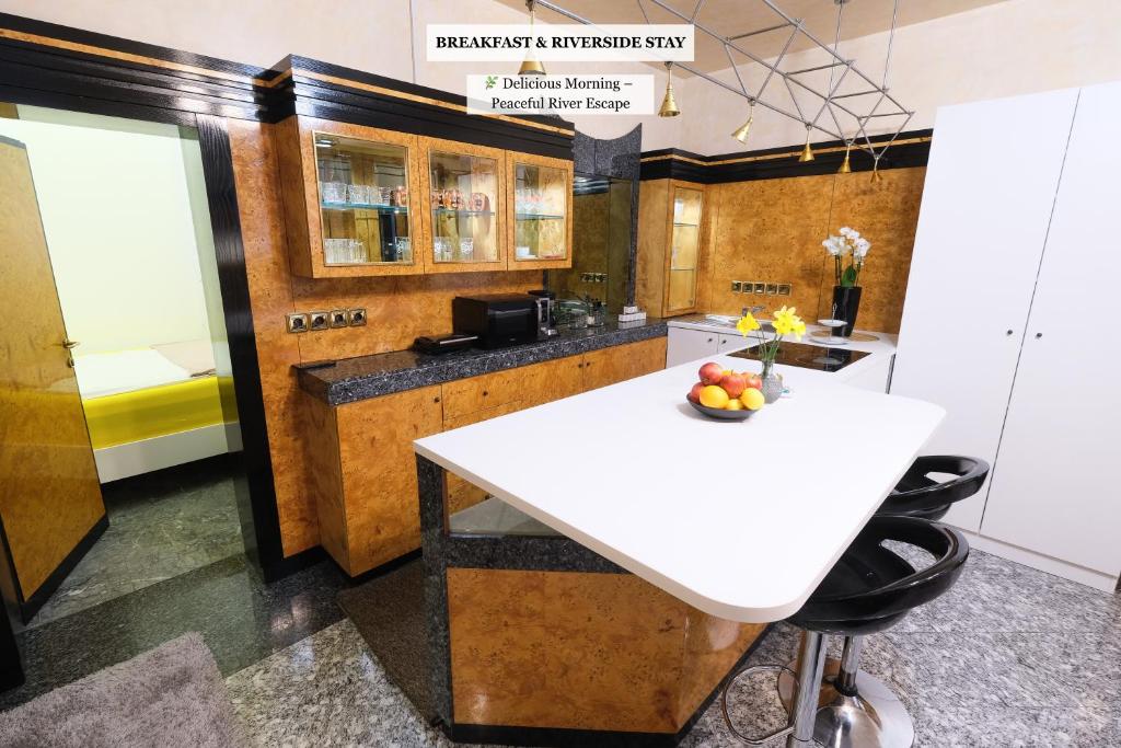a kitchen with a white table and some chairs at Apartments Perla in Krško