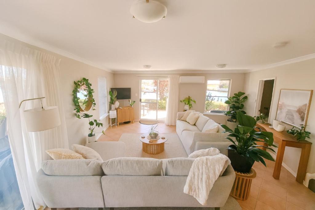 a living room with two white couches at Waterfront bliss, spacious corner block in Mandurah