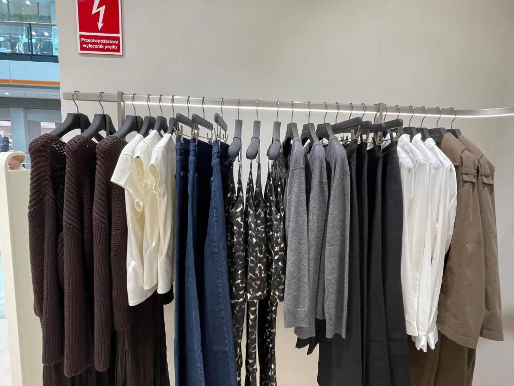 a bunch of clothes on a rack in a store at R Zajad Witnica in Witnica
