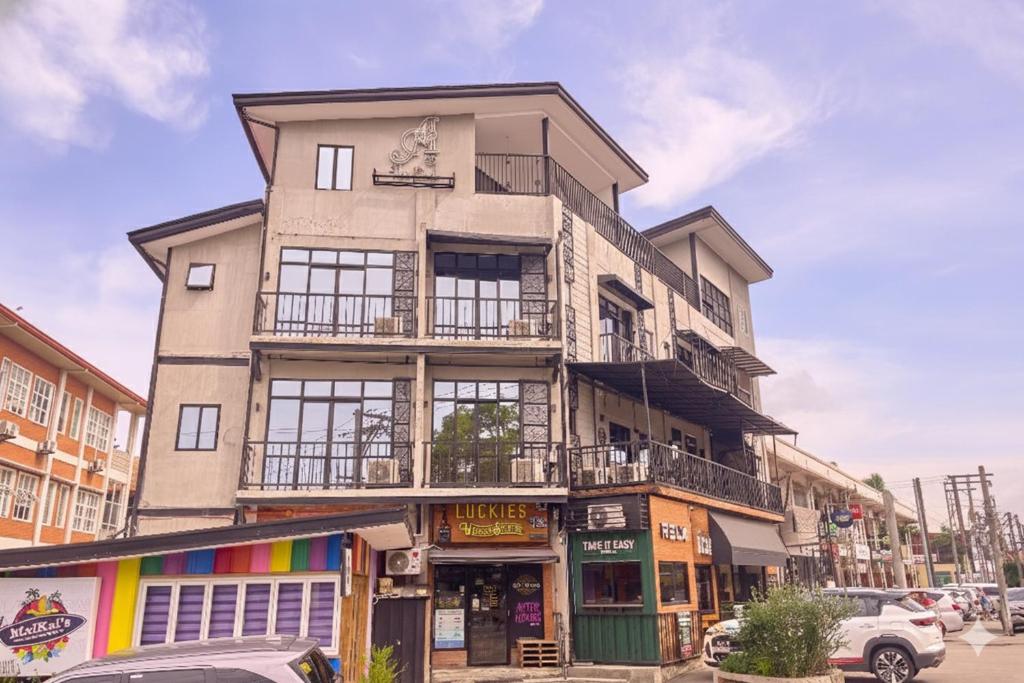 a tall building on the corner of a street at Auberge Petit Hotel San Juan La Union in san juan la union