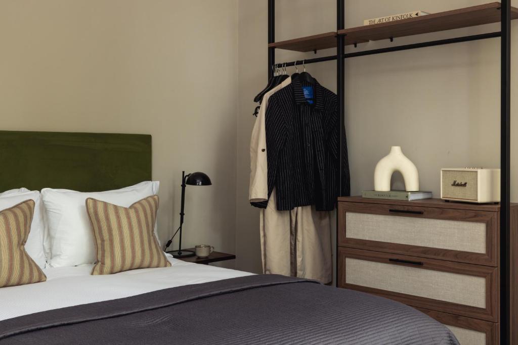 a bedroom with a bed and a dresser at Native Hyde Park in London