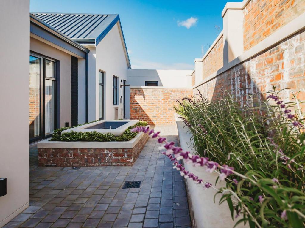 a courtyard of a home with a brick wall at 40 Ridge Drive, Kingswood Golf Estate in George