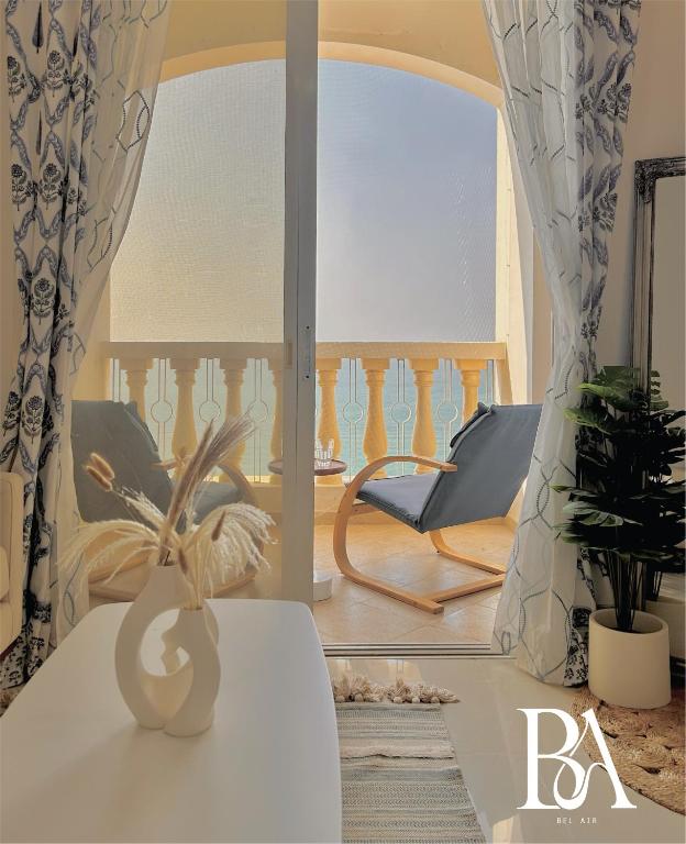 a living room with a vase on a table at Bel Air -- Sea View Studio in Ras al Khaimah